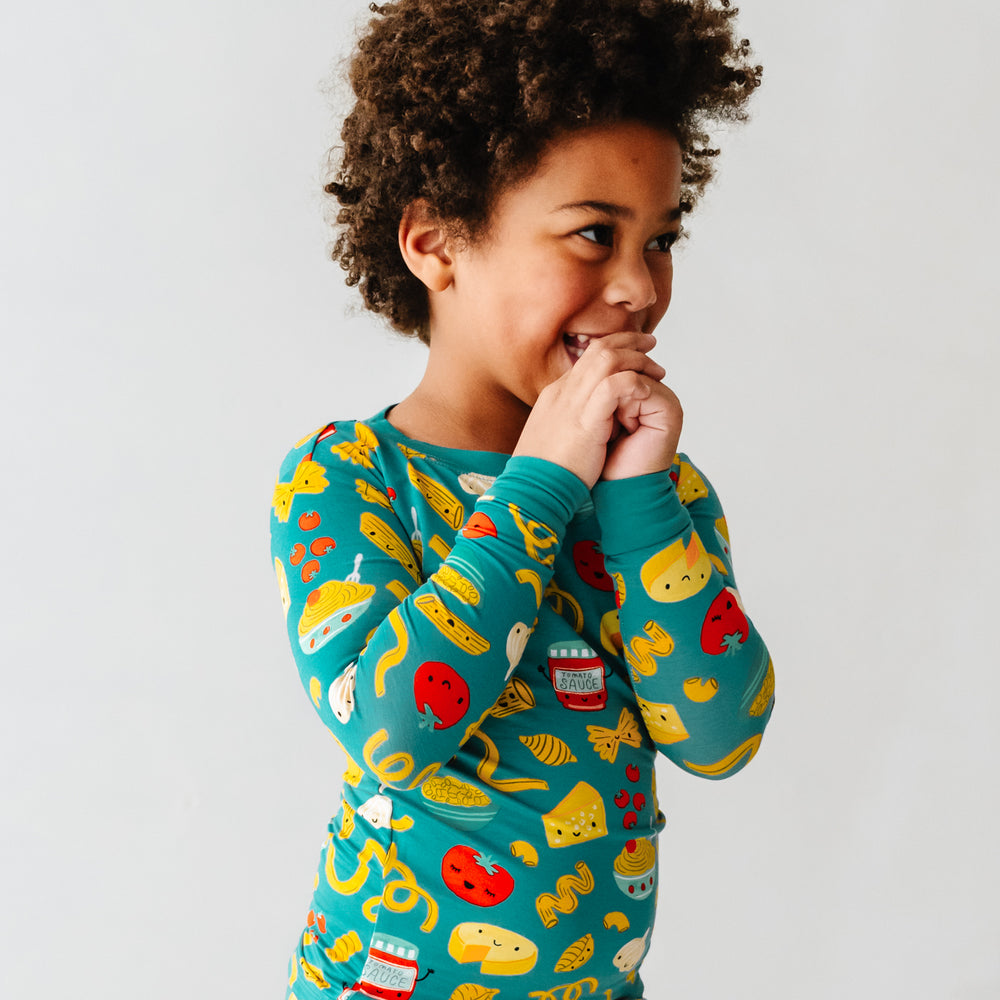Click to see full screen - Close up image of a child wearing a Pasta Party two-piece pajama set