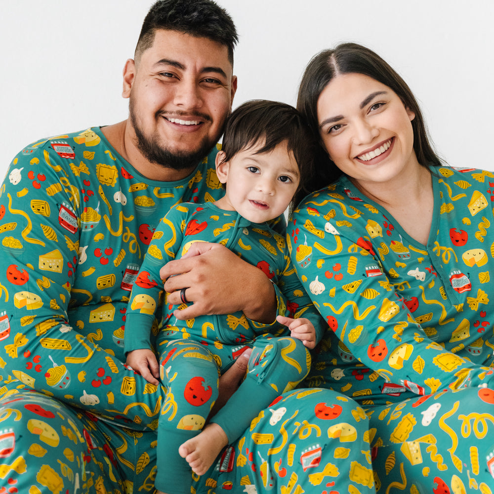 Click to see full screen - Close up image of a family of three wearing matching Pasta Party pajamas