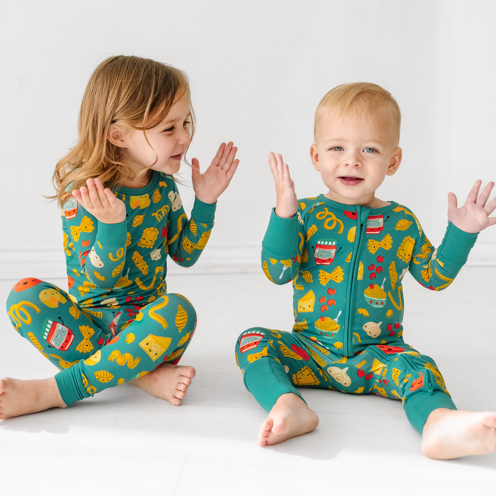 Click to see full screen - Two children clapping their hands wearing matching Pasta Party pajamas