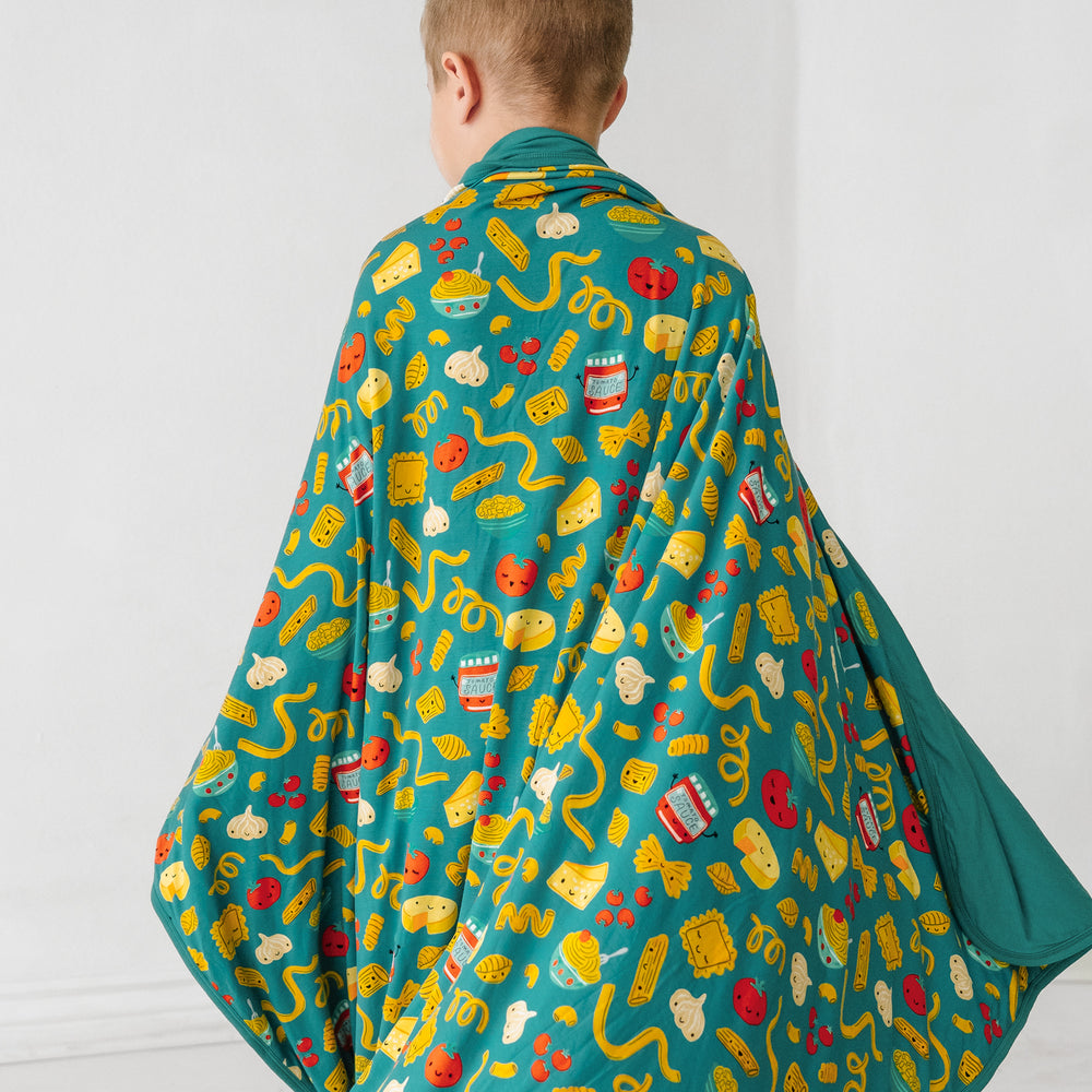Click to see full screen - Back view image of a child spinning around with a Pasta Party large cloud blanket draped over them
