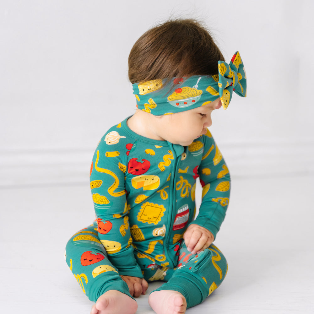 Click to see full screen - Child looking to the side wearing a Pasta Party luxe bow headband and matching pajamas