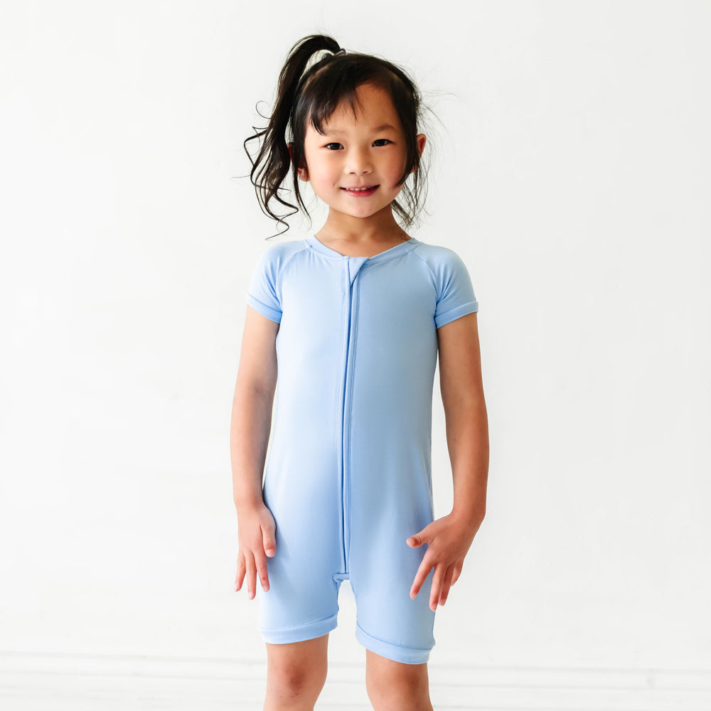 Child posing wearing a Periwinkle Blue shorty romper