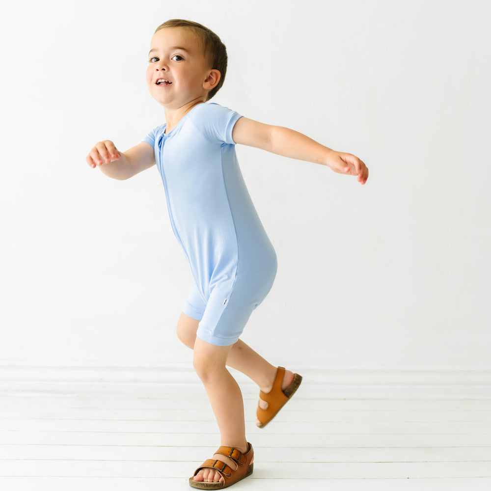 Child twirling wearing a Periwinkle Blue shorty romper