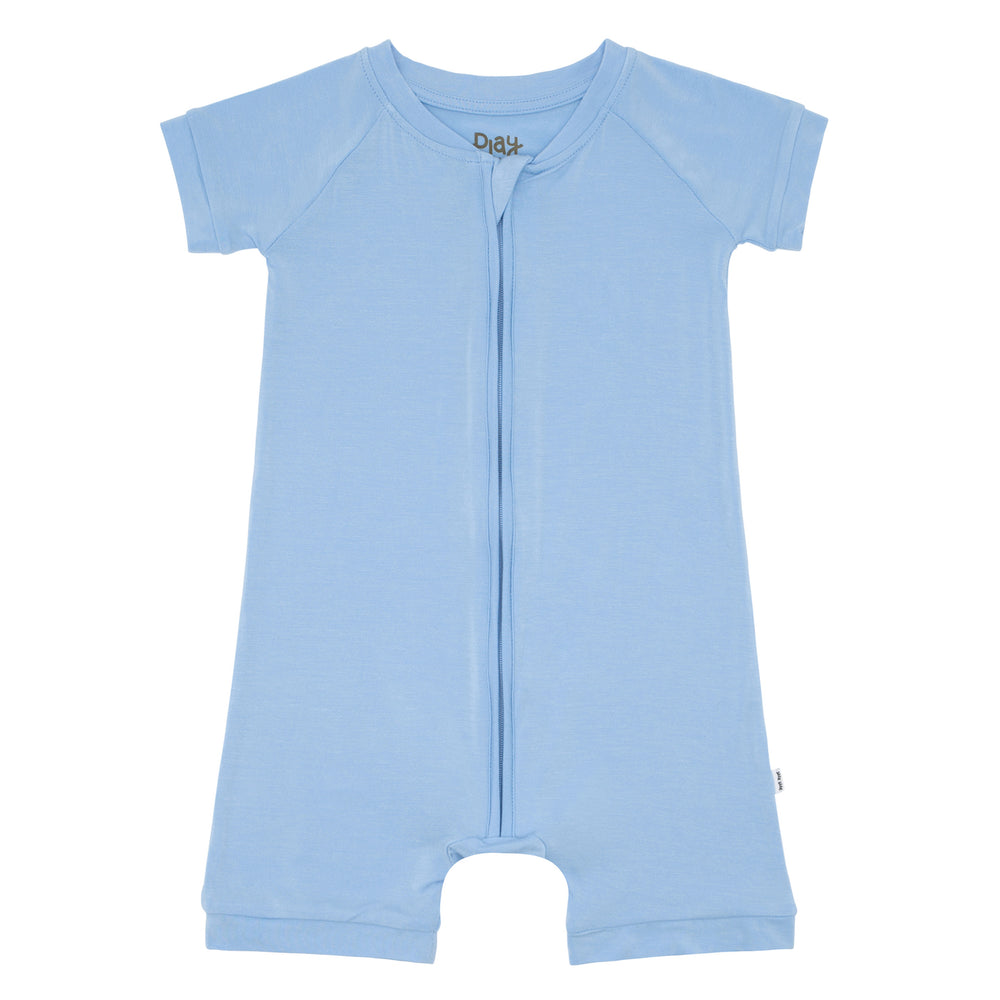 Flat lay image of a Periwinkle Blue shorty romper 