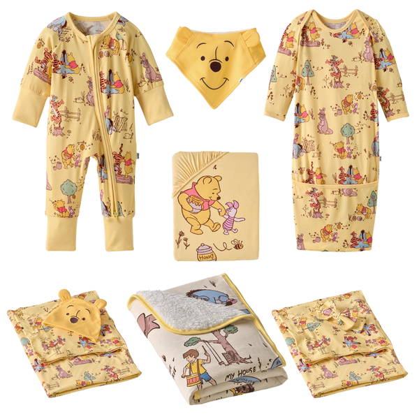Playtime With Pooh newborn set, which includes a Zippy, Infant Gown, Bandana Bib, Fitted Crib Sheet, Swaddle & Hat Set, Swaddle & Luxe Bow Headband Set, and Mini Cloud Blanket®.