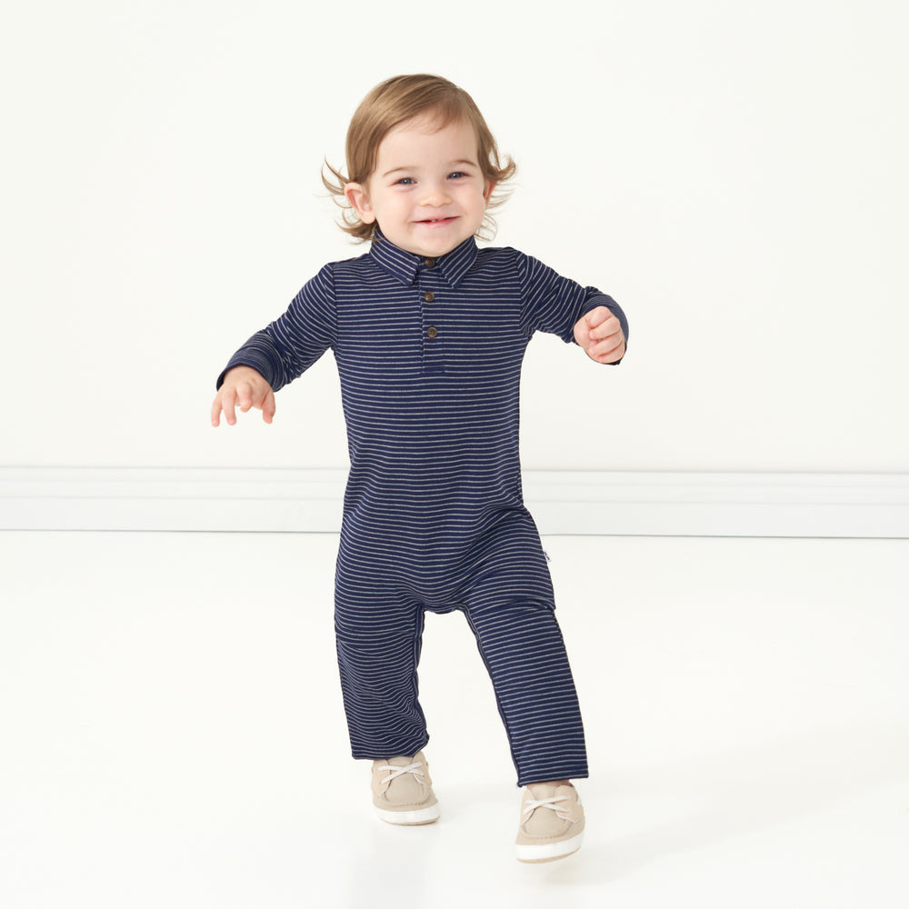 Child wearing a Classic Navy Stripes polo romper