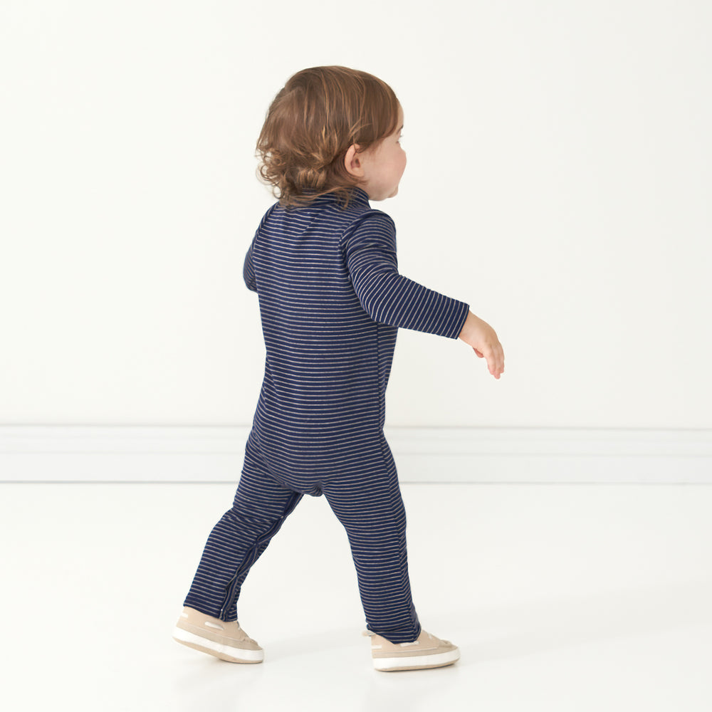 Back view image of a child wearing a Classic Navy Stripes polo romper