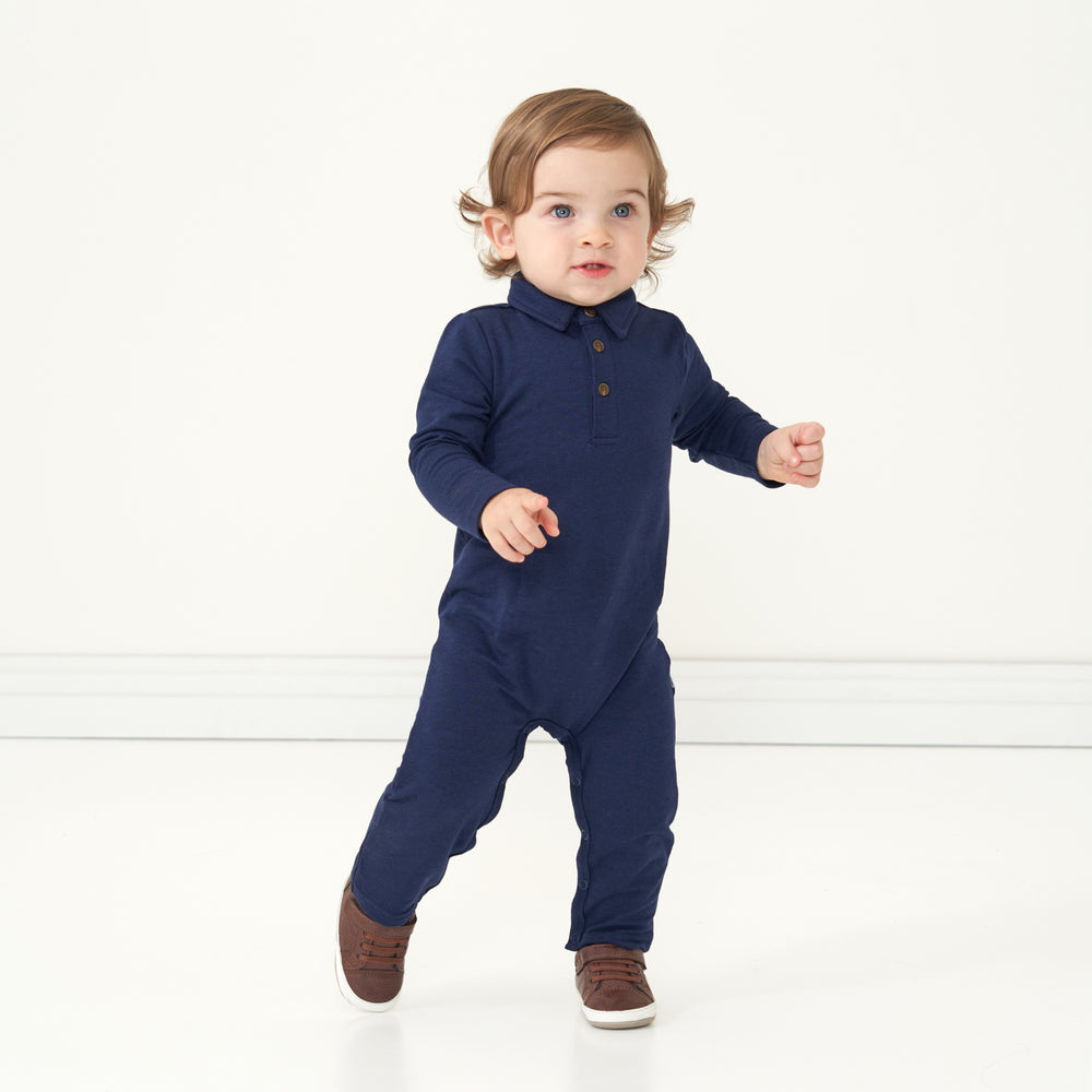 Child walking wearing a Classic Navy polo romper