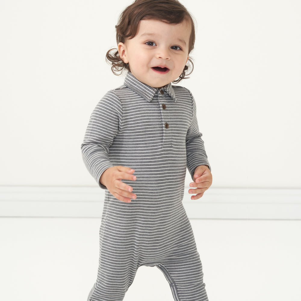 Close up image of a child wearing a Heather Charcoal Stripes polo romper