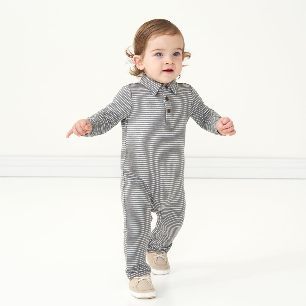 Small child walking wearing a Heather Charcoal Stripes polo romper