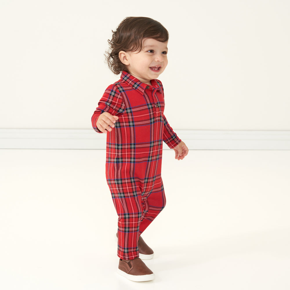 Side view image of a child wearing a Holiday Plaid polo romper