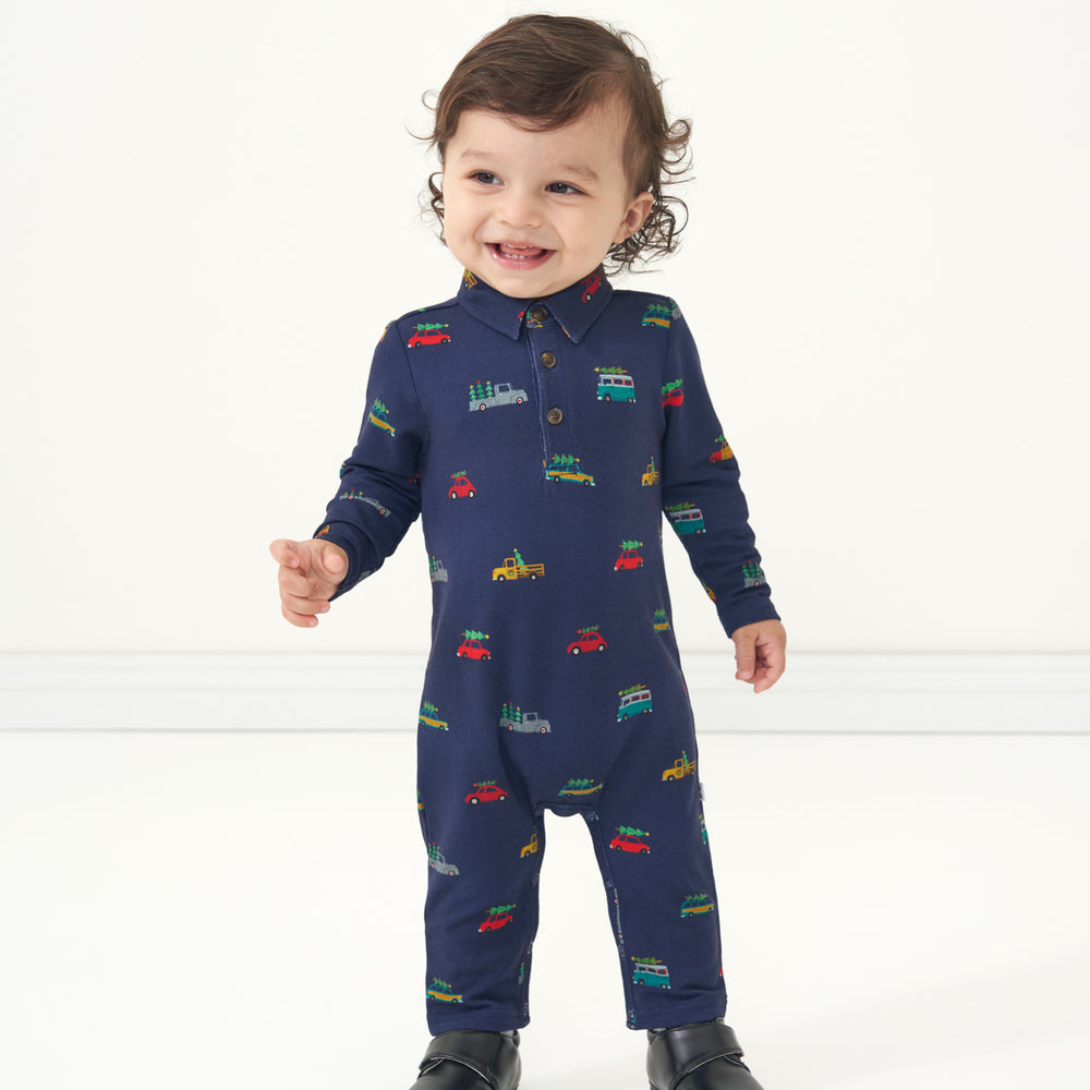 Child laughing wearing a Tree Traffic polo romper