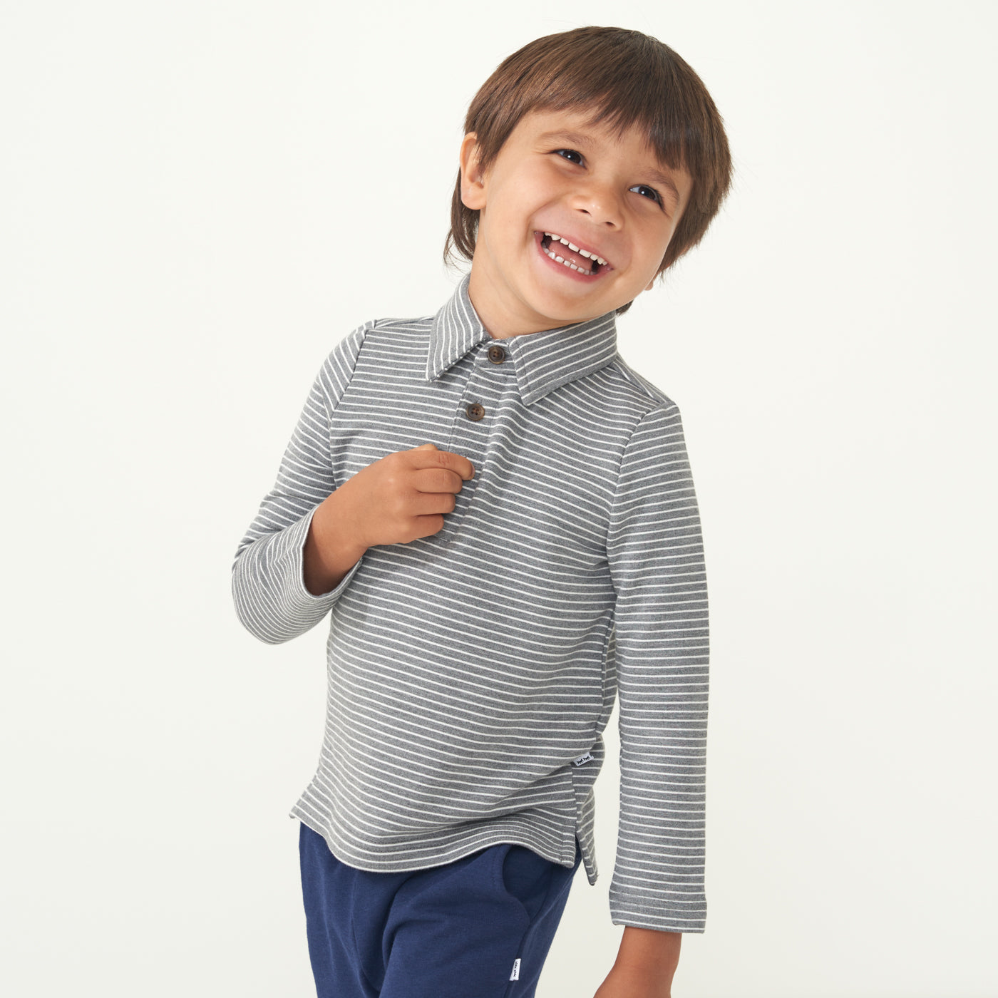 Child posing wearing a Heather Charcoal stripes polo shirt paired with Sapphire joggers