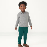 Child wearing a Heather Charcoal stripes polo shirt paired with Emerald joggers