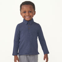 Child wearing a Classic Navy Stripes polo shirt