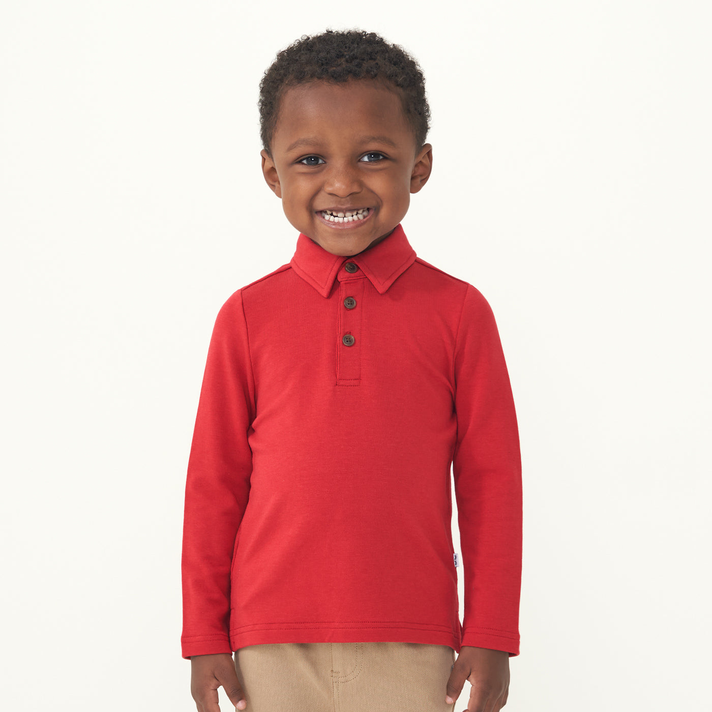 Child wearing a Holiday Red polo shirt