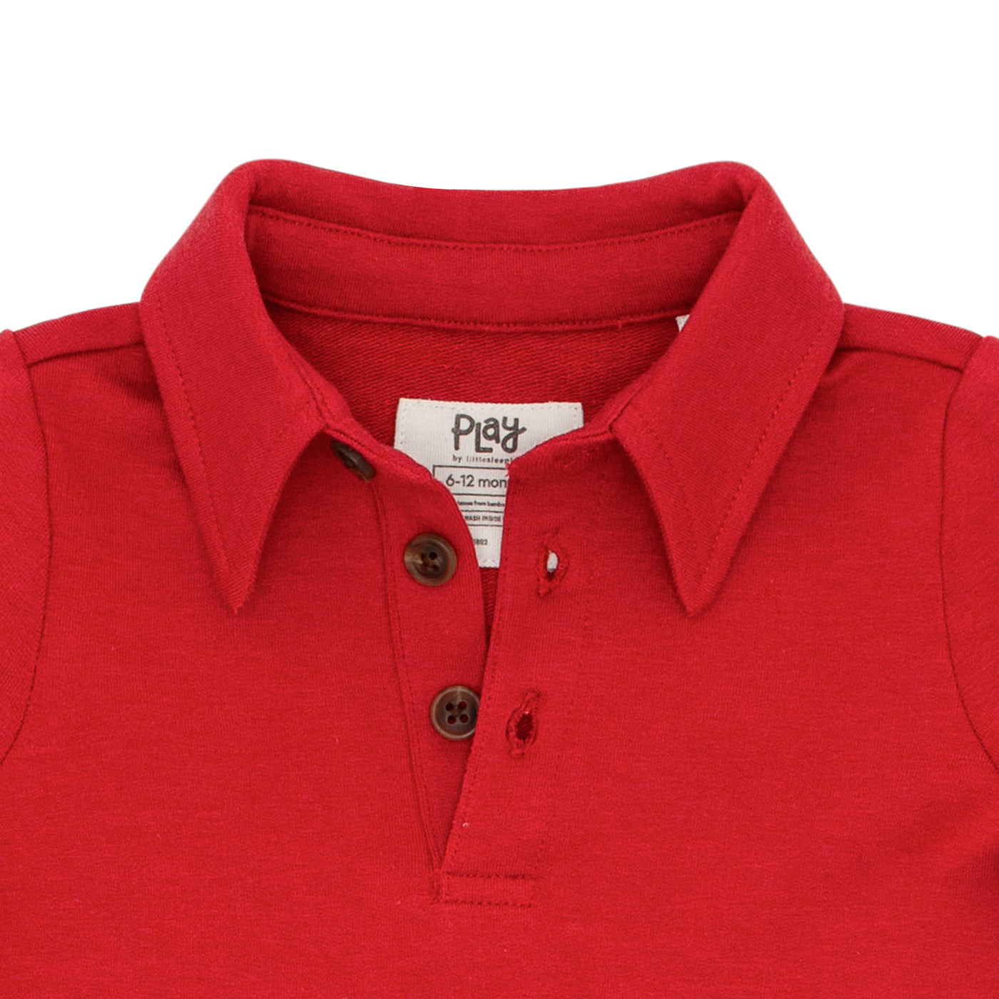 Close up image detailing the buttons on a Holiday Red polo shirt