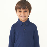Close up image of a child wearing a Classic Navy polo shirt