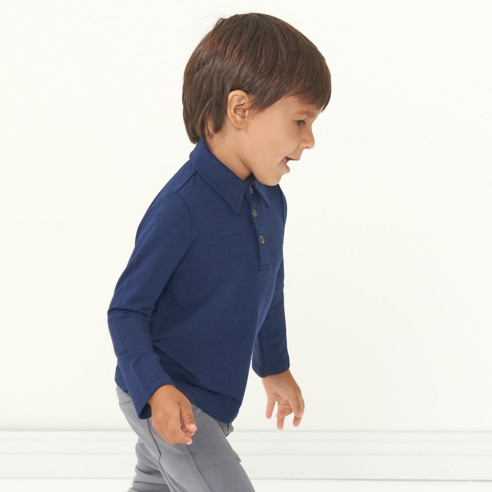 Side view image of a child wearing a Classic Navy polo shirt