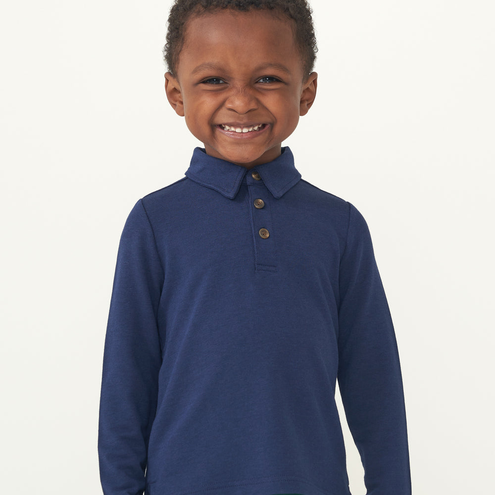 Child laughing wearing a Classic Navy polo shirt