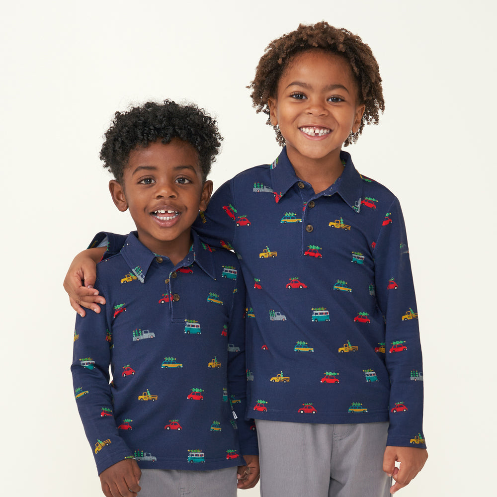 Two children wearing matching Tree Traffic polo shirts