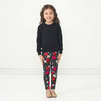 Alternate image of a child wearing a Black pom pom sweater and coordinating Berry Merry leggings