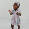 Video of a child wearing a Playful Plaid puff sleeve button down dress with bloomer and matching luxe bow headband