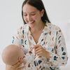 Video of a woman wearing a Luna Neutral women's sleep shirt holding her baby wearing a Luna Neutral zippy