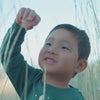 Video of boy climbing and playing while wearing the Heritage Green Graphic Crewneck