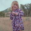 Video of girl walking and holding flowers while wearing the Violet Meadow Bow Back Skater Dress