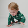 Crawling baby wearing the Twinkling Trees Holiday Zippy