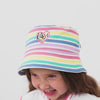 Video of a child wearing a Bluey rainbow bucket hat and coordinating outfit