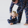 Video of a family wearing matching Santa's Sleigh pajamas