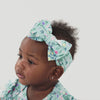Video of a child wearing a Bunny Blossom luxe bow headband and matching bodysuit