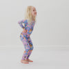 Jumping child wearing the Bluey Purple Sleepytime Two-Piece Long Sleeve & Pants Pajama Set