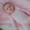 Aerial view of newborn wearing the Prima Pink Stripe Flutter Bodysuit on a pink mini cloud blanket
