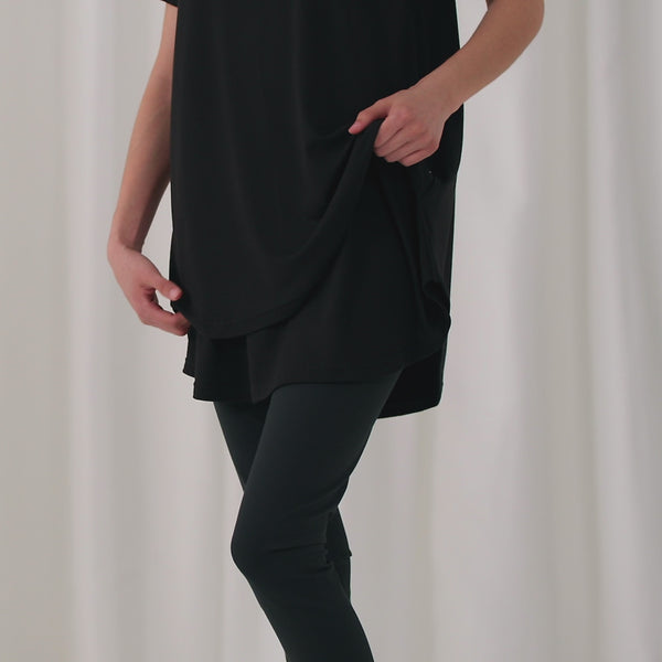 Video of a woman wearing and demonstrating a Black women's nursing top