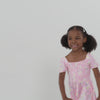 Video of a child wearing a Rosy Meadow puff sleeve smocked dress