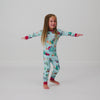 Spinning child wearing the Disney & Pixar Christmas Village Two-Piece Pajama Set