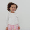Video of a child wearing an Ivory ruffle cardigan and coordinating skort
