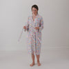 Woman putting on the Tiny Blooms Women's Robe