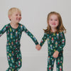 Two children wearing matching Nutcracker March Two-Piece Pajama Sets