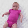 Video of an infant laying on a blanket wearing a Rogue Pink Flutter Bodysuit