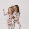 Video of two girls jumping and playing while wearing the Modern & Merry Two-Piece Pajama Set