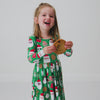 Child in motion wearing the Cookies for Santa Bow Back Skater Dress 