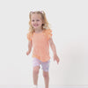 Video of a child wearing a Peach Nectar flutter tee and coordinating Play bottoms