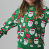 Girl wearing the Cookies for Santa Crewneck Sweatshirt with a Santa hat