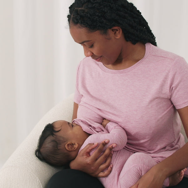 Video of a woman wearing and demonstrating a Heather Mauve women's nursing top