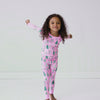 Video of a child wearing a Pink Twinkling Trees Two-Piece Pajama Set