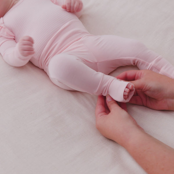 Adult demonstrating the foot fold over feature on the Prima Pink Fold-Over Legging